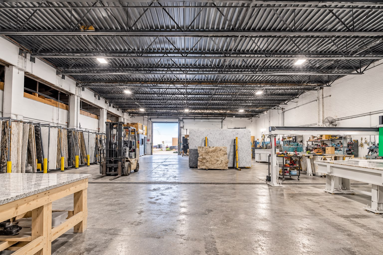 Open warehouse floor with forklift and drive-in door at JA Transportation & Warehousing