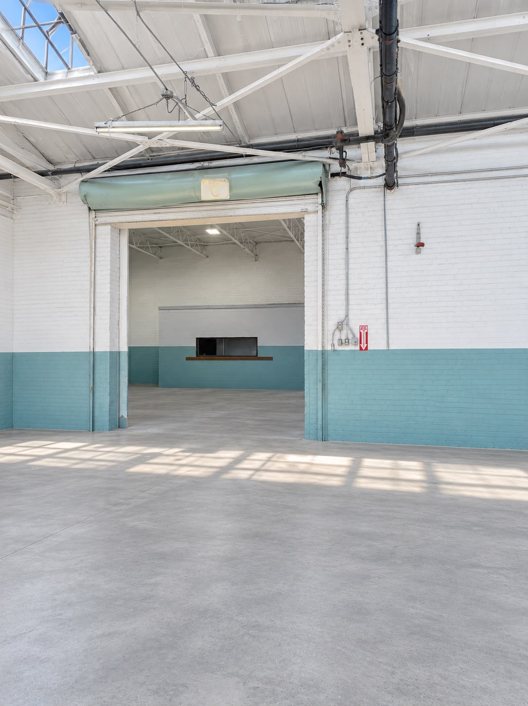 Roll-up door opening into a separate warehouse storage room at JA Transportation & Warehousing