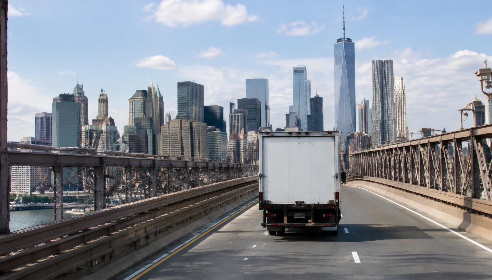 Box truck driving toward the Manhattan skyline on Philadelphia to New York freight lane