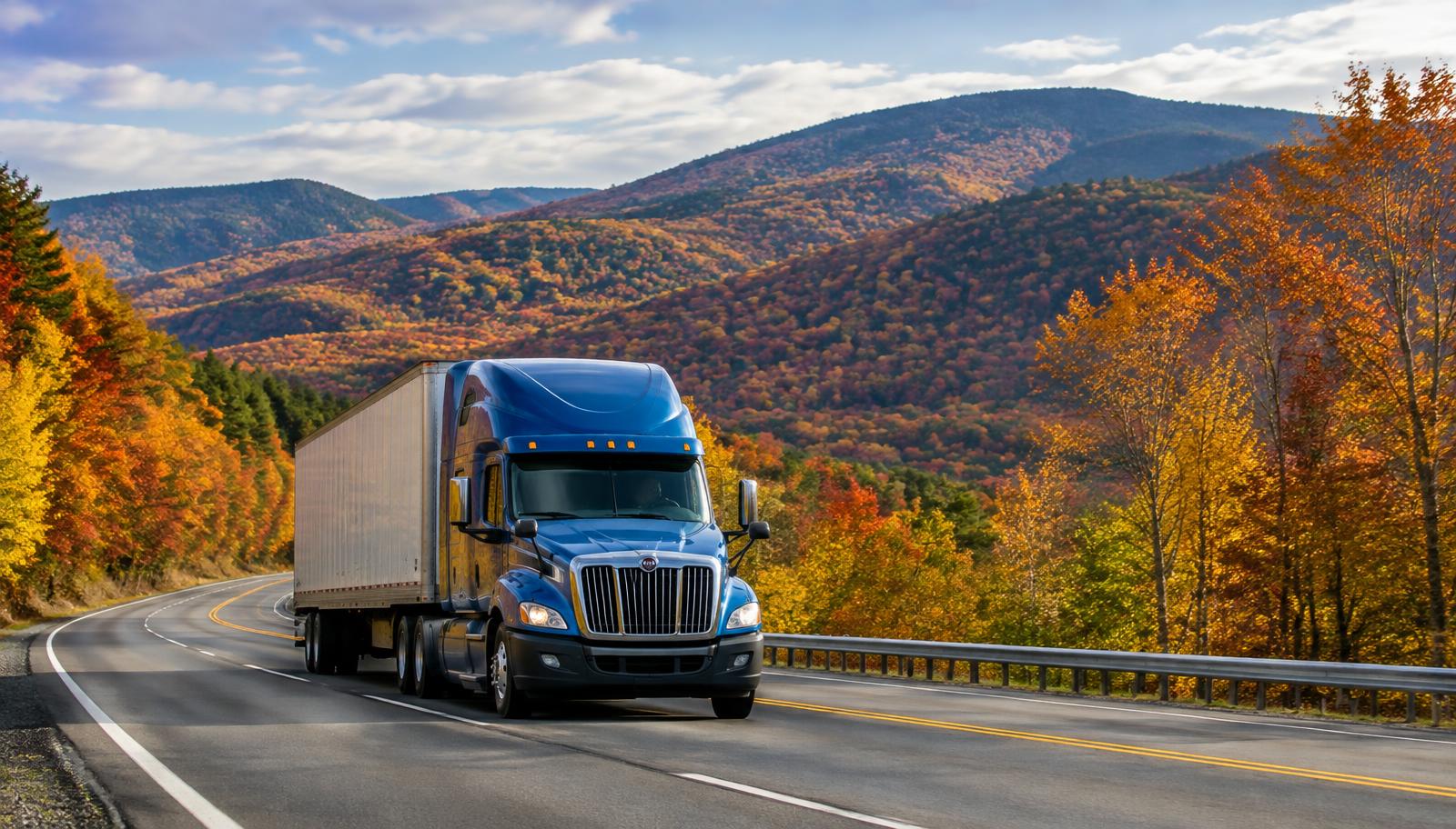 Semi truck on an upstate New York mountain highway in autumn